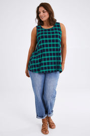 Model Monique wearing size 14 of The Printed Drape Tank in colour Navycheck (Blue), from the front, showing the whole outfit
