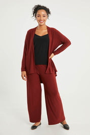 Model Noli wearing size 14 of The Recycled Flounce Cardigan in colour Terracotta, from the front, showing the whole outfit
