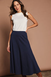Model Madeline wearing size 10 of The Fit And Flare Ponte Skirt in colour Frenchnavy (Blue), from the front, cropped image