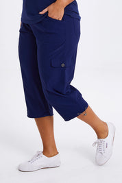 Model Monique wearing size 14 of The Everyday Cropped Cargo Pant in colour Frenchblue (Blue), from the front, cropped image