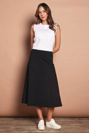 Model Madeline wearing size 10 of The Fit & Flare Summer Skirt in colour Black (Black), from the front, showing the whole outfit