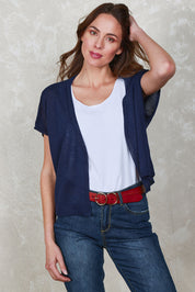 Model Madeline wearing size S of The Short Sleeve Shrug in colour Clasicnavy (Blue), from the front, showing the whole outfit