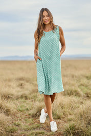 Model Amanda wearing size 10 of The Keepers Lined Swing Dress in colour Sagegreen (Green), from the front, showing the whole outfit