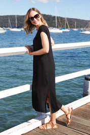 Model Alex wearing size 8 of The Mid Length Tee Dress in colour Black (Black), from the front, showing the whole outfit
