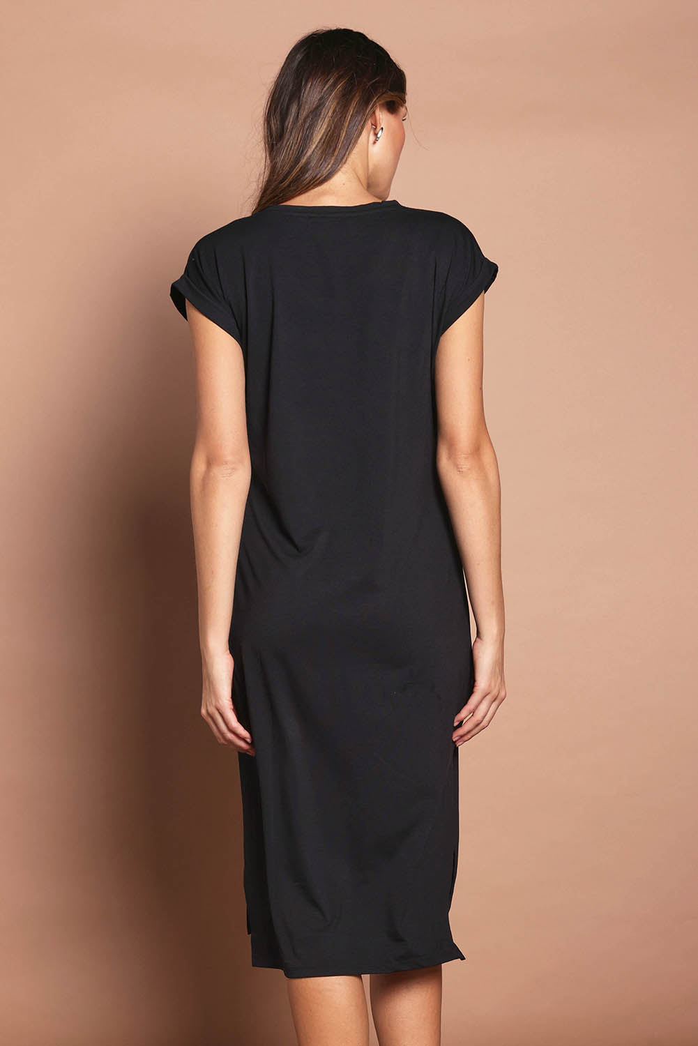 Model Madeline wearing size 10 of The Mid Length Tee Dress in colour Black (Black), from the back