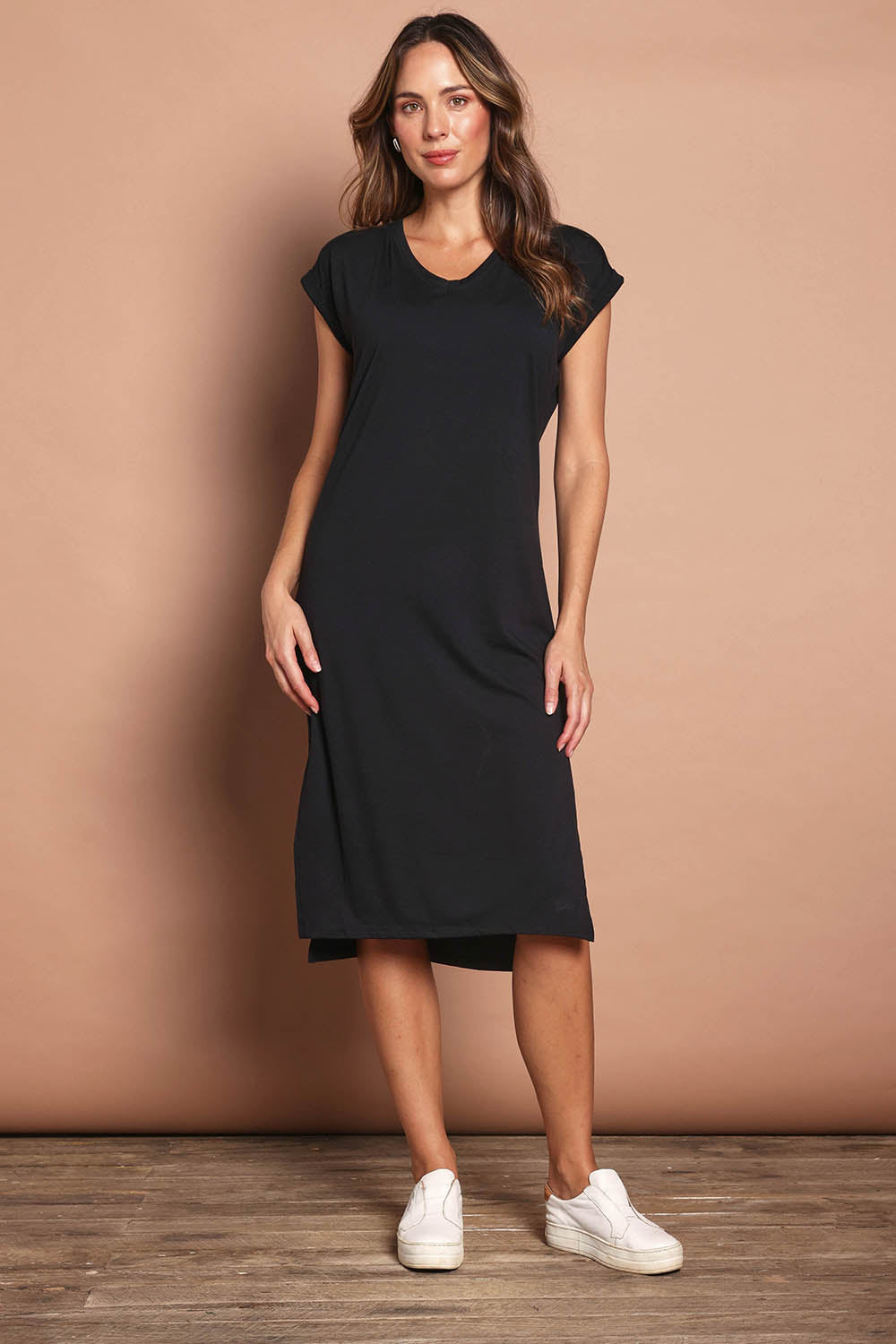 Model Madeline wearing size 10 of The Mid Length Tee Dress in colour Black (Black), from the front, showing the whole outfit