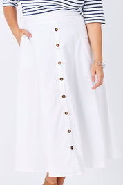 Model Mae wearing size 16 of The Button Up Midi Skirt in colour White (White), from the front, cropped image