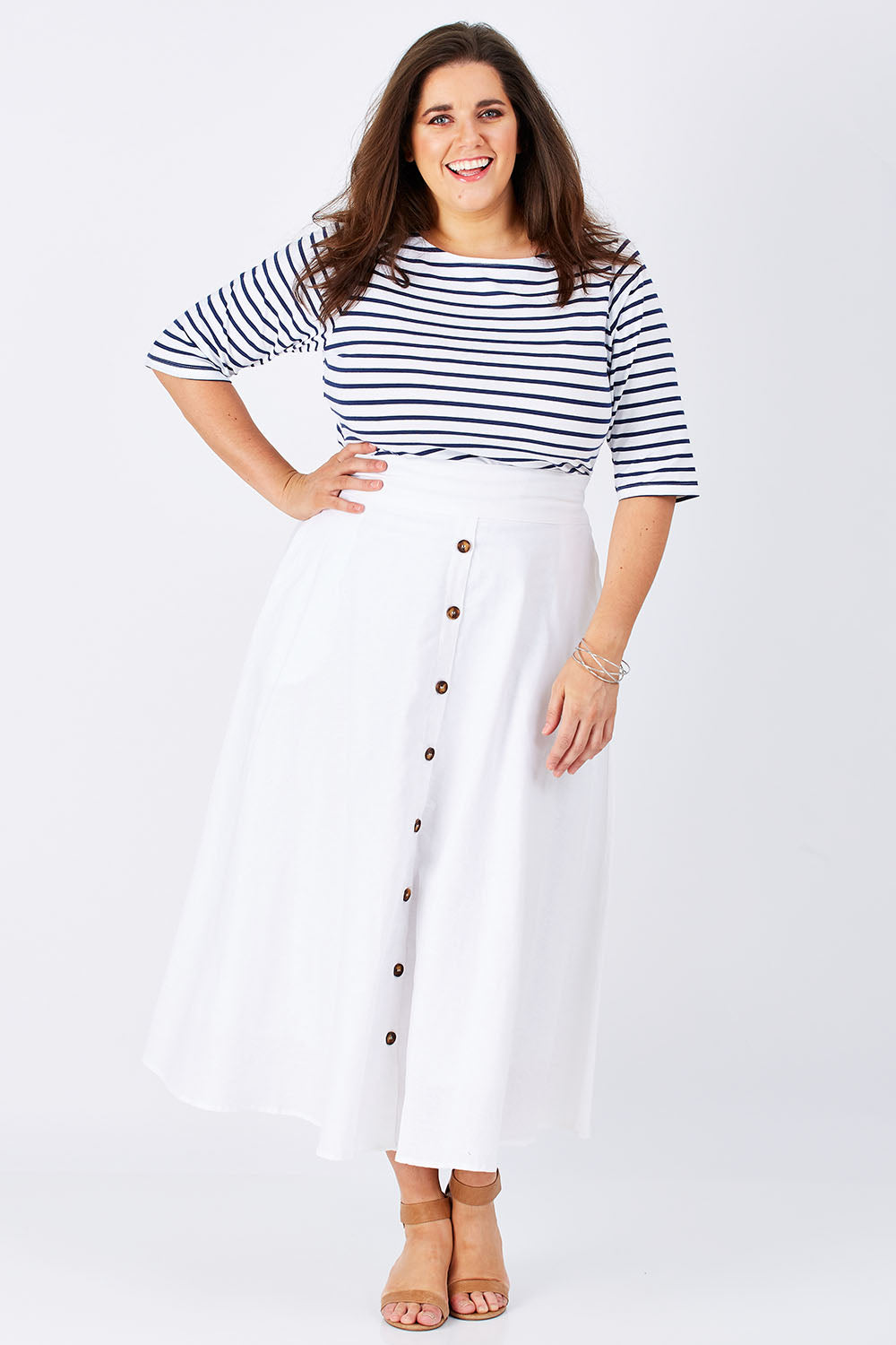 Model Mae wearing size 16 of The Button Up Midi Skirt in colour White (White), from the front, showing the whole outfit