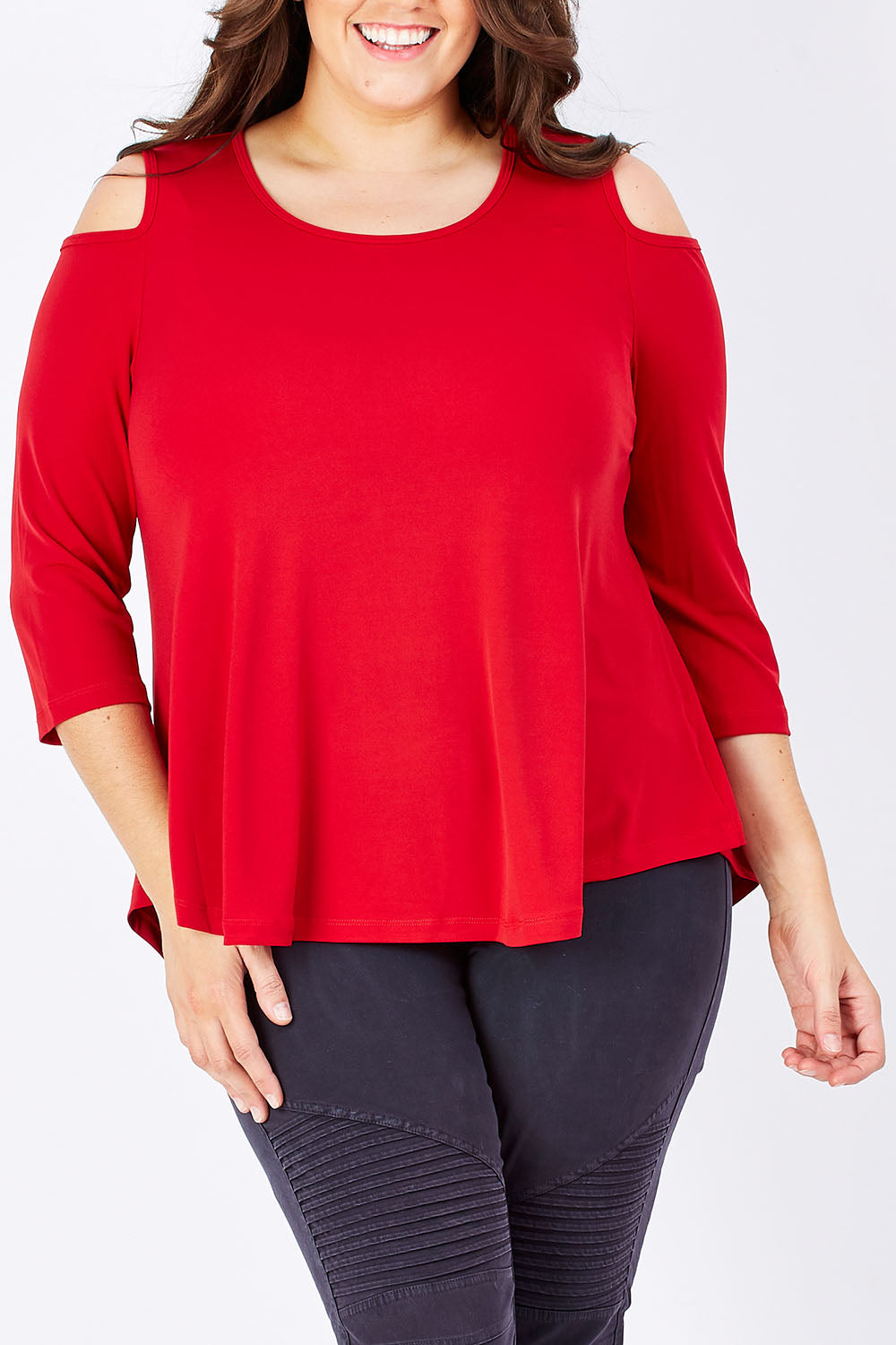 Model Mae wearing size 16 of The Cut Out Shoulder Top in colour Red (Red), from the front, cropped image