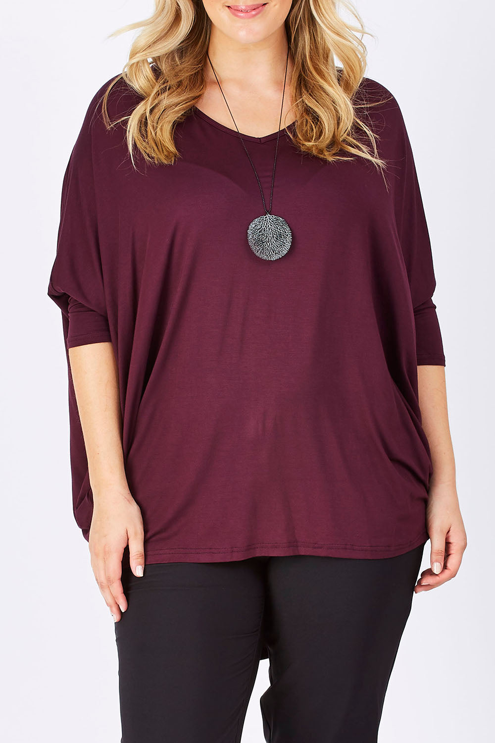 Model Jess wearing size 14 of The V Neck Side Drape Tee in colour Wine (Purple), from the front, cropped image