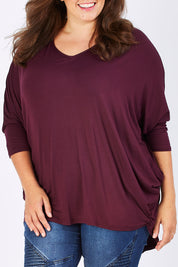 Model Mae wearing size 18 of The V Neck Side Drape Tee in colour Wine (Purple), from the front, cropped image