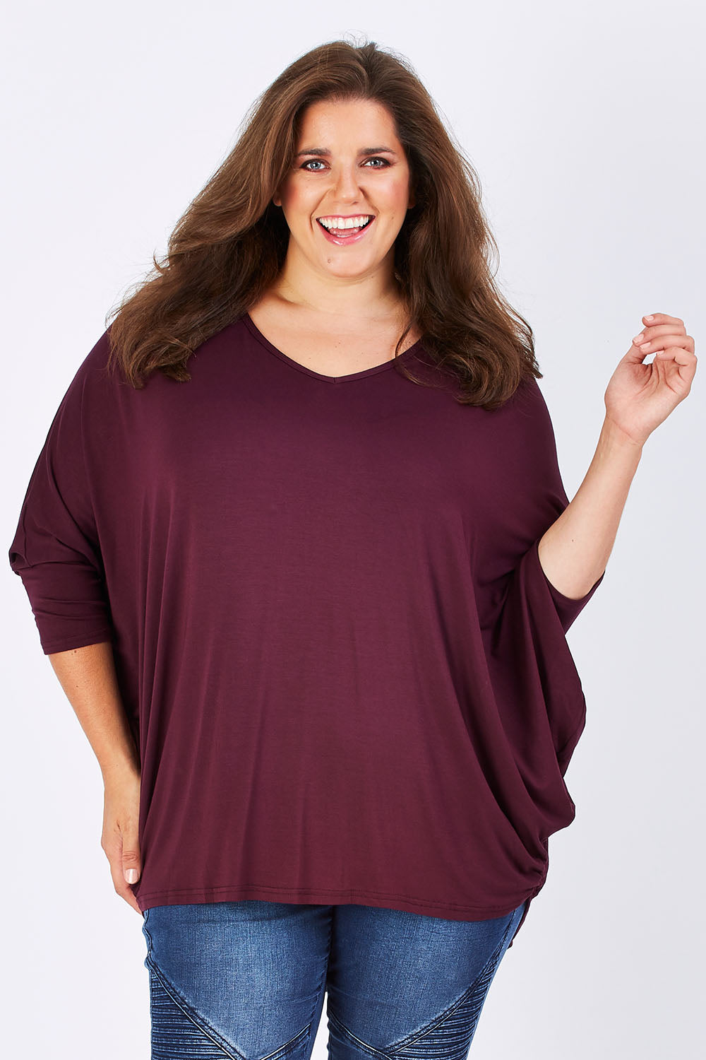 Model Mae wearing size 18 of The V Neck Side Drape Tee in colour Wine (Purple), from the front, cropped image