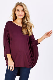 Model Marnee wearing size 10 of The V Neck Side Drape Tee in colour Wine (Purple), from the front, cropped image