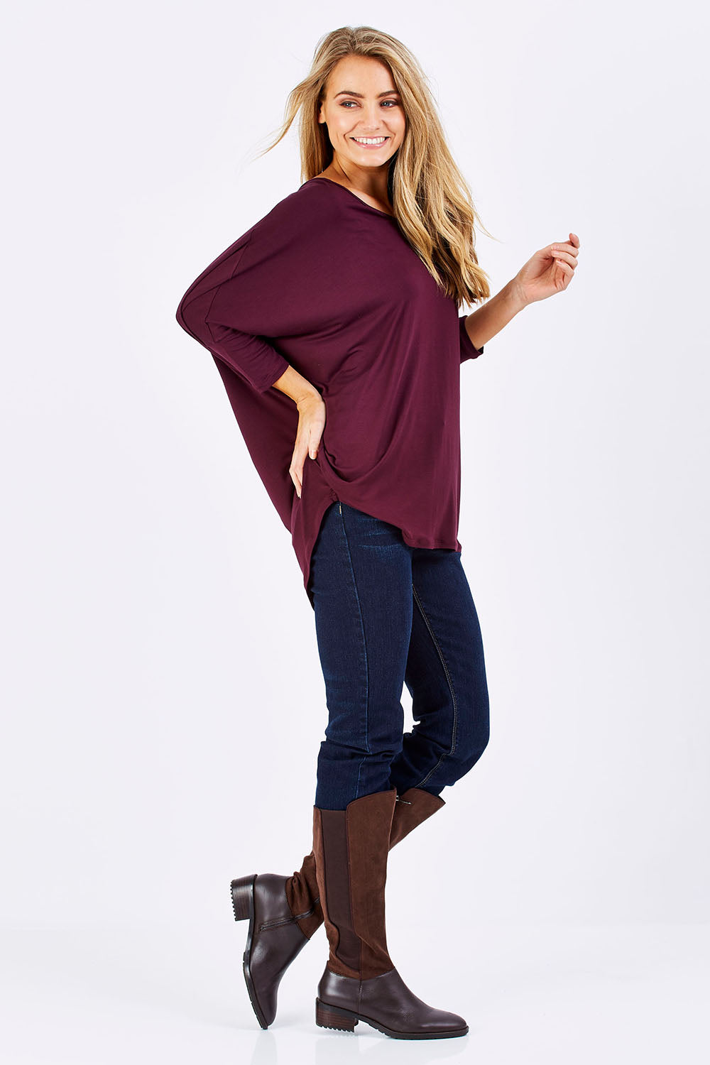 Model Marnee wearing size 10 of The V Neck Side Drape Tee in colour Wine (Purple), from the front, showing the whole outfit