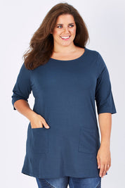 Model Mae wearing size 10 of The Pocket Tunic Top in colour Navy (Blue), from the front, cropped image