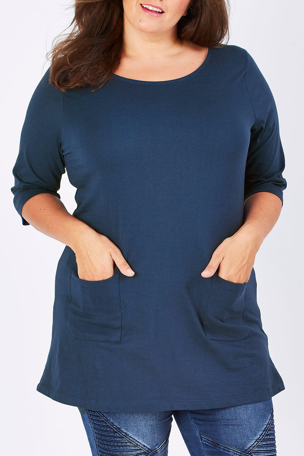 Model Mae wearing size 18 of The Pocket Tunic Top in colour Navy (Blue), from the front, cropped image