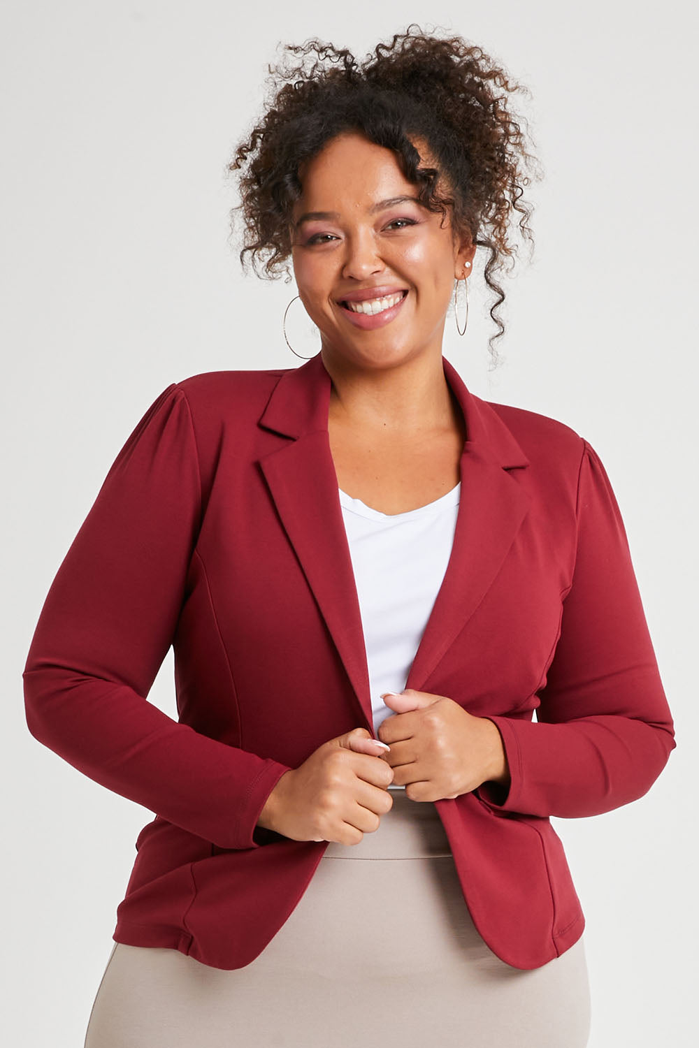 Model Alexis wearing size 16 of The Ponte Blazer in colour Wildberry (Red), from the front, cropped image