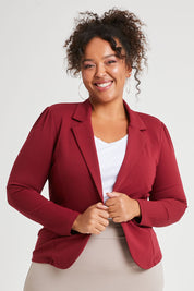 Model Alexis wearing size 16 of The Ponte Blazer in colour Wildberry (Red), from the front, cropped image