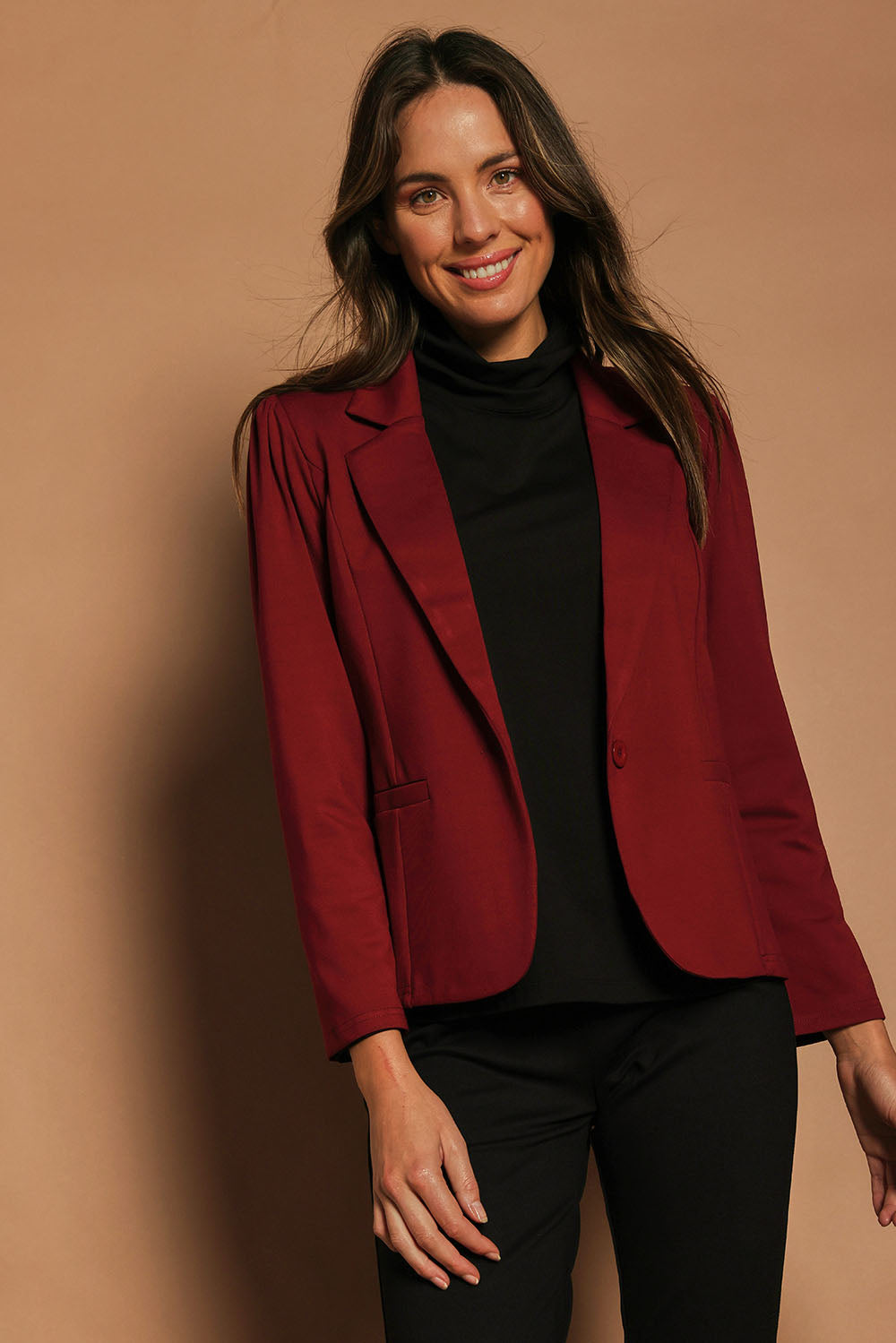 Model Madeline wearing size 10 of The Ponte Blazer in colour Wildberry (Red), from the front, cropped image