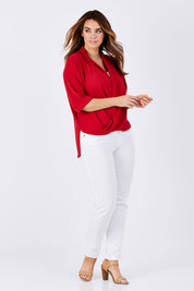 Model Laura wearing size 12 of The Cross Over Blouse in colour Red (Red), from the front, showing the whole outfit