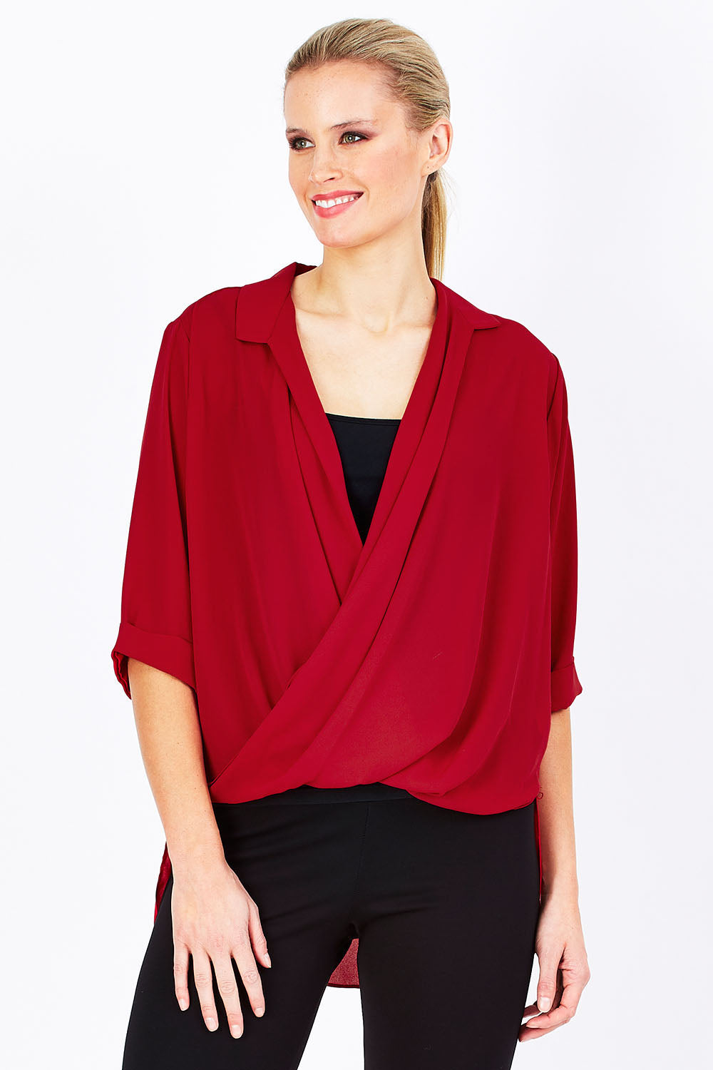 Model Maddy wearing size 10 of The Cross Over Blouse in colour Red (Red), from the front, cropped image