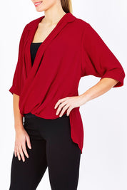 Model Maddy wearing size 10 of The Cross Over Blouse in colour Red (Red), from the front, cropped image