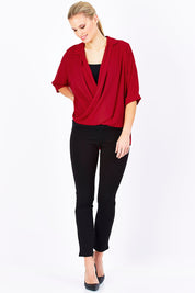 Model Maddy wearing size 10 of The Cross Over Blouse in colour Red (Red), from the front, showing the whole outfit