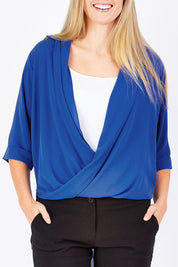 Model Maddy wearing size 10 of The Cross Over Blouse in colour RoyalBlue (Blue), from the front, cropped image