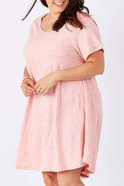 Model Mae wearing size 16 of The Swing Dress in colour Pink (Pink), from the front, cropped image