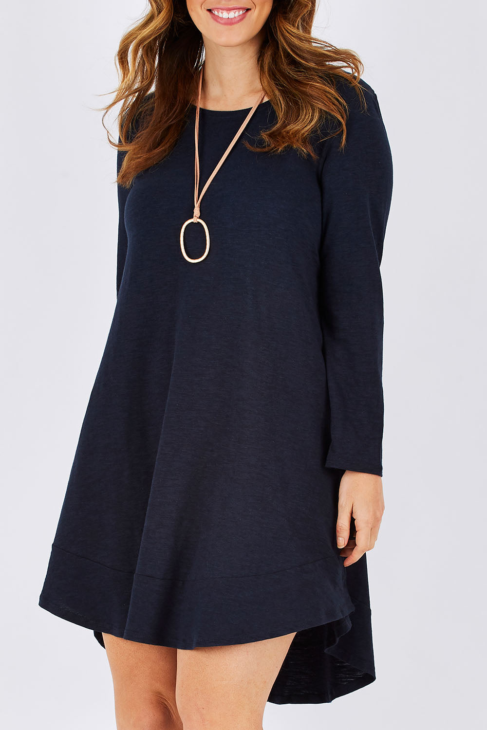 Model Laura wearing size 12 of The Long Sleeve Swing Dress in colour Navy (Blue), from the front, cropped image