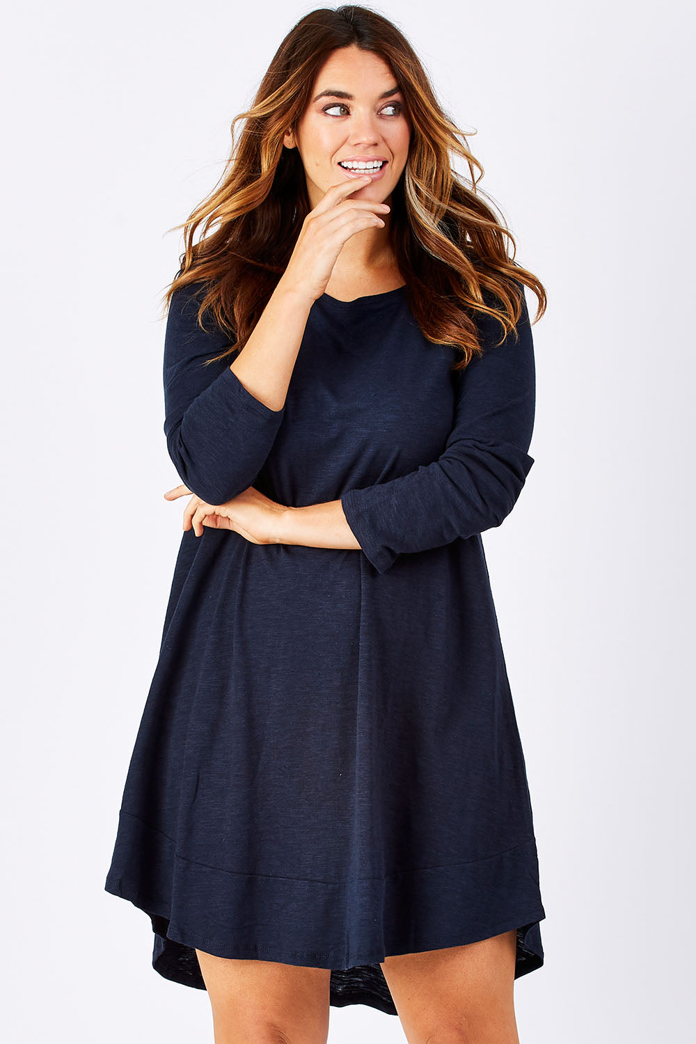 Model Laura wearing size 12 of The Long Sleeve Swing Dress in colour Navy (Blue), from the front, cropped image