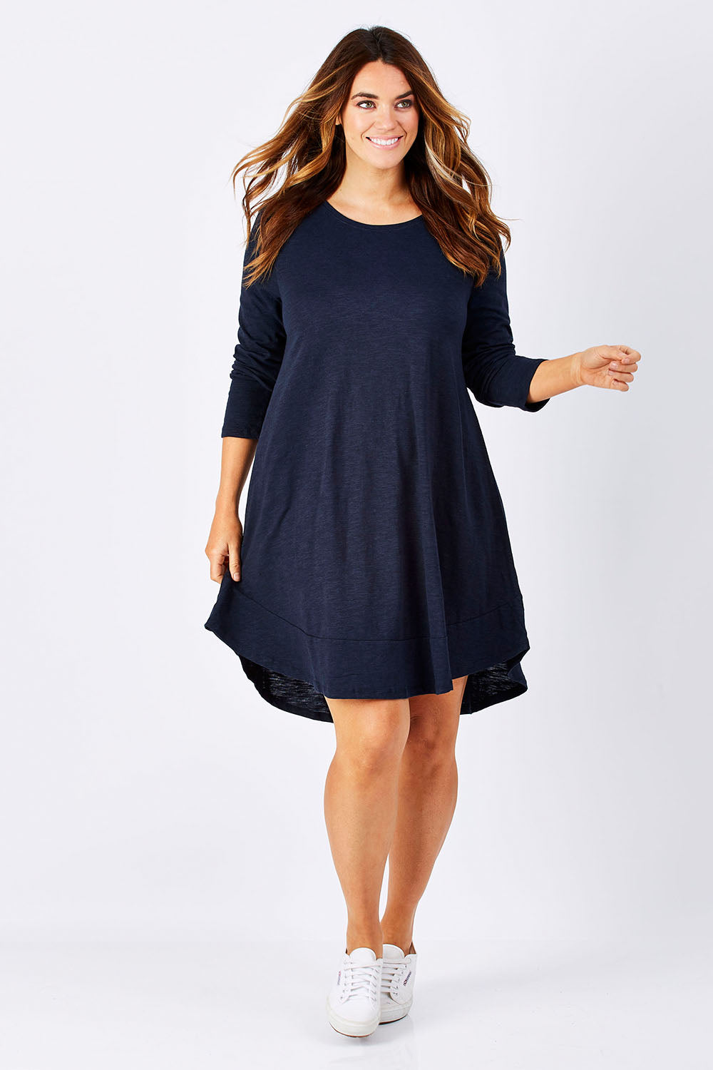 Model Laura wearing size 12 of The Long Sleeve Swing Dress in colour Navy (Blue), from the front, showing the whole outfit