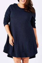 Model Mae wearing size 18 of The Long Sleeve Swing Dress in colour Navy (Blue), from the front, cropped image