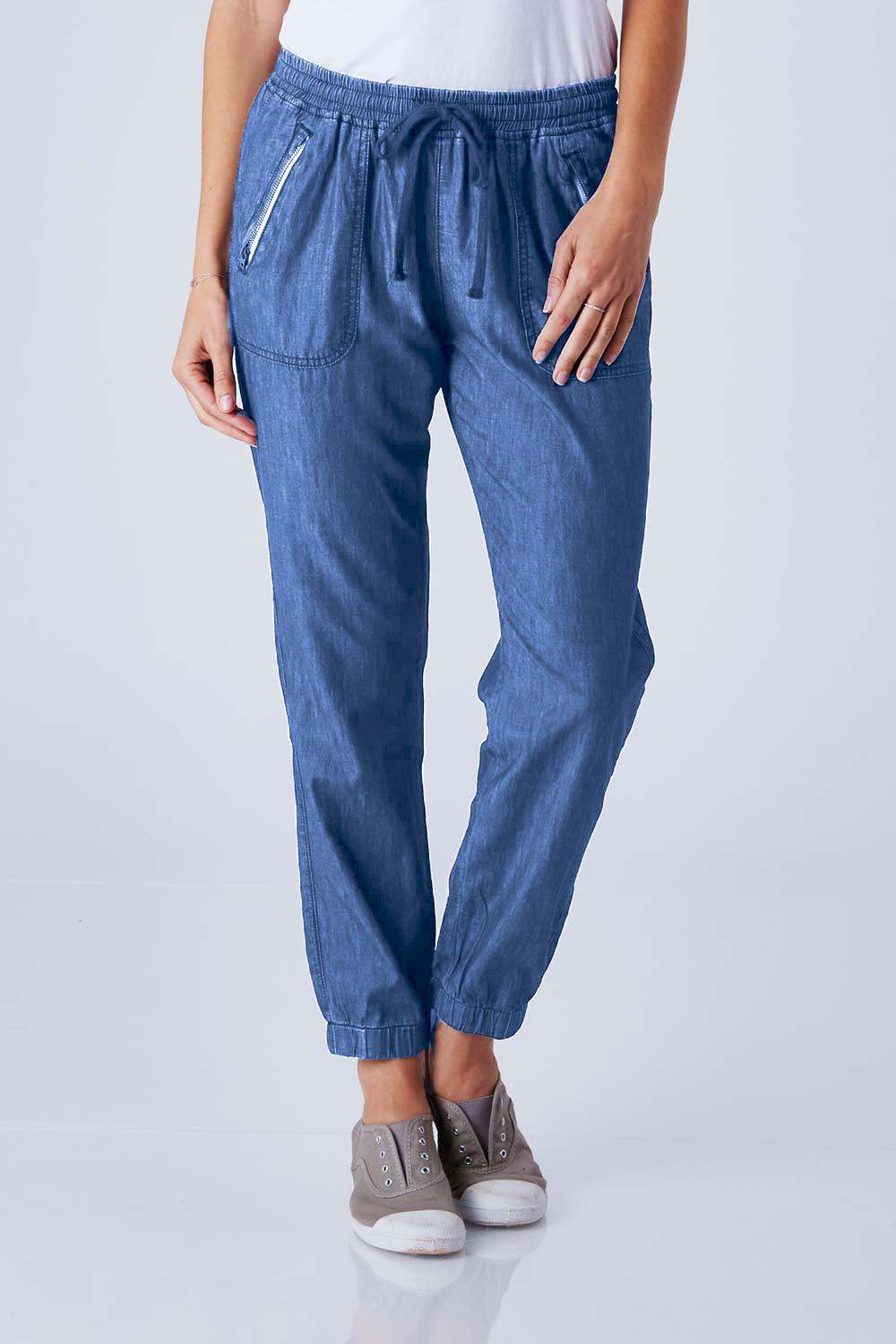 Model Anna wearing size 10 of The Chambray Pant in colour DarkChamb (Blue), from the front, cropped image