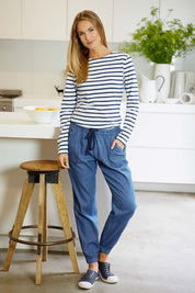 Model Nathalie wearing size 10 of The Chambray Pant in colour DarkChamb (Blue), from the front, showing the whole outfit