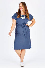 Model Sophie wearing size 14 of The Tie Waist Midi Dress in colour Ink Blue (Blue), from the front, showing the whole outfit