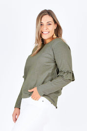Model Natalia wearing size 14 of The Ruffle Sleeve Sweat in colour KhakiMarle (Green), from the front, cropped image