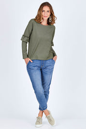 Model Riina wearing size 10 of The Ruffle Sleeve Sweat in colour KhakiMarle (Green), from the front, showing the whole outfit