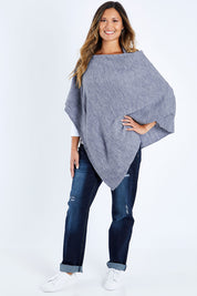 Model Kimberley wearing size S of The Perfect Poncho in colour Bluemarle (Blue), from the front, showing the whole outfit