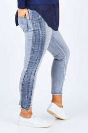 Model Jess wearing size 14 of The Step Hem Jean in colour Blue (Blue), from the front, cropped image