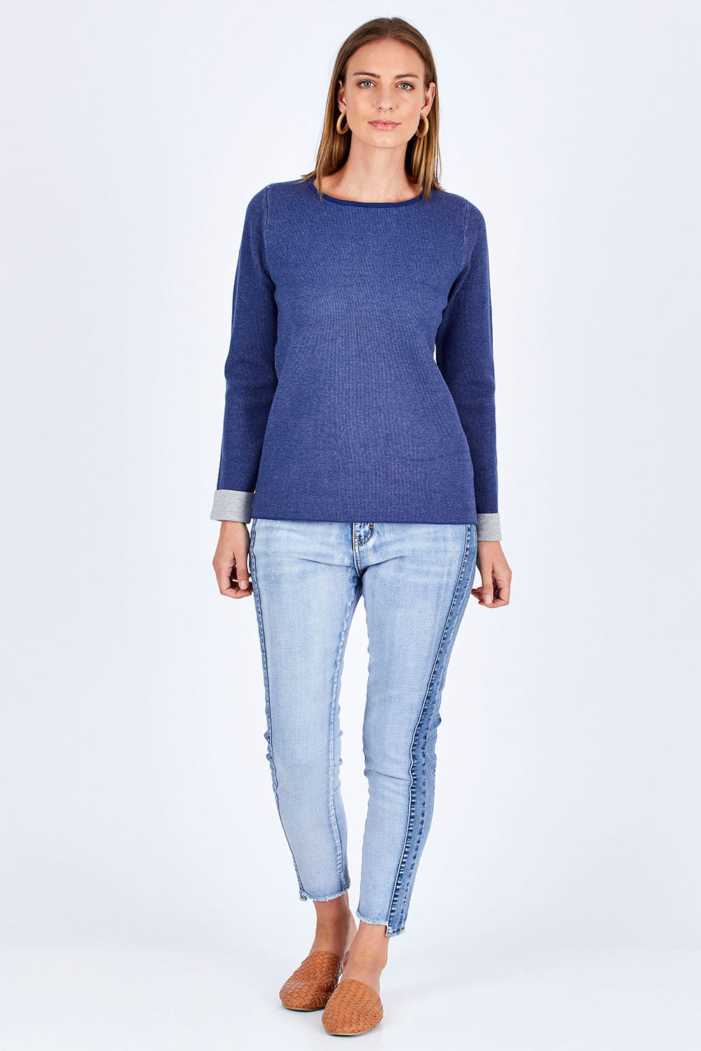 Model Riina wearing size 10 of The Step Hem Jean in colour Blue (Blue), from the front, showing the whole outfit