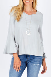 Model Anna wearing size 10 of The Bell Sleeve Top in colour Grey (Grey), from the front, cropped image