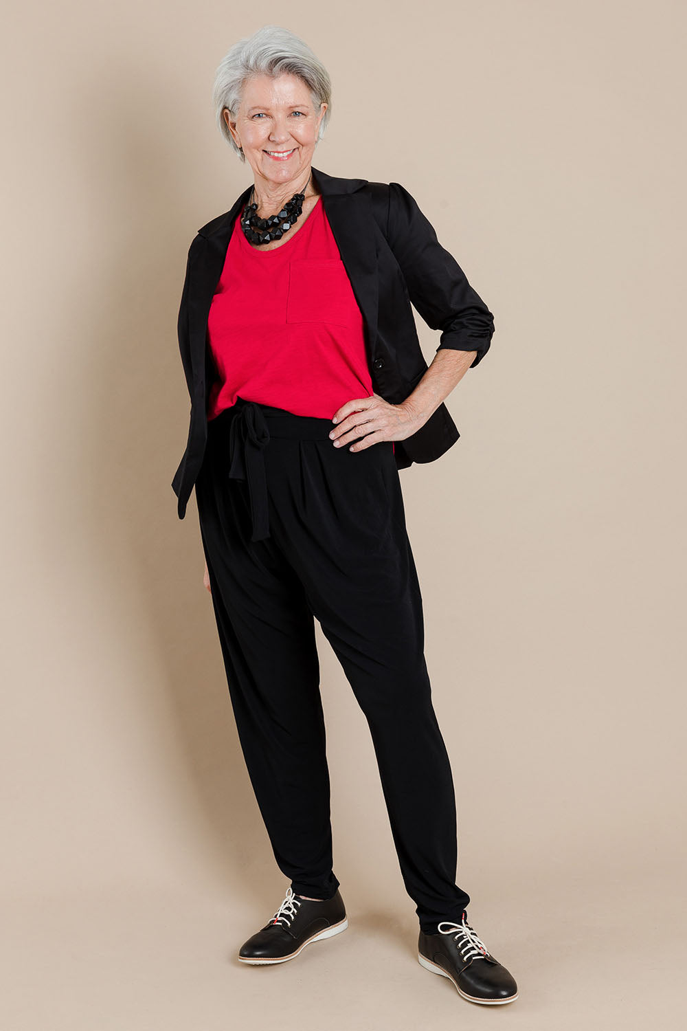 Model Elise wearing size 10 of The Comfort Pant in colour Black (Black), from the front, showing the whole outfit