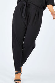 Model Laura wearing size 14 of The Comfort Pant in colour Black (Black), from the front, cropped image