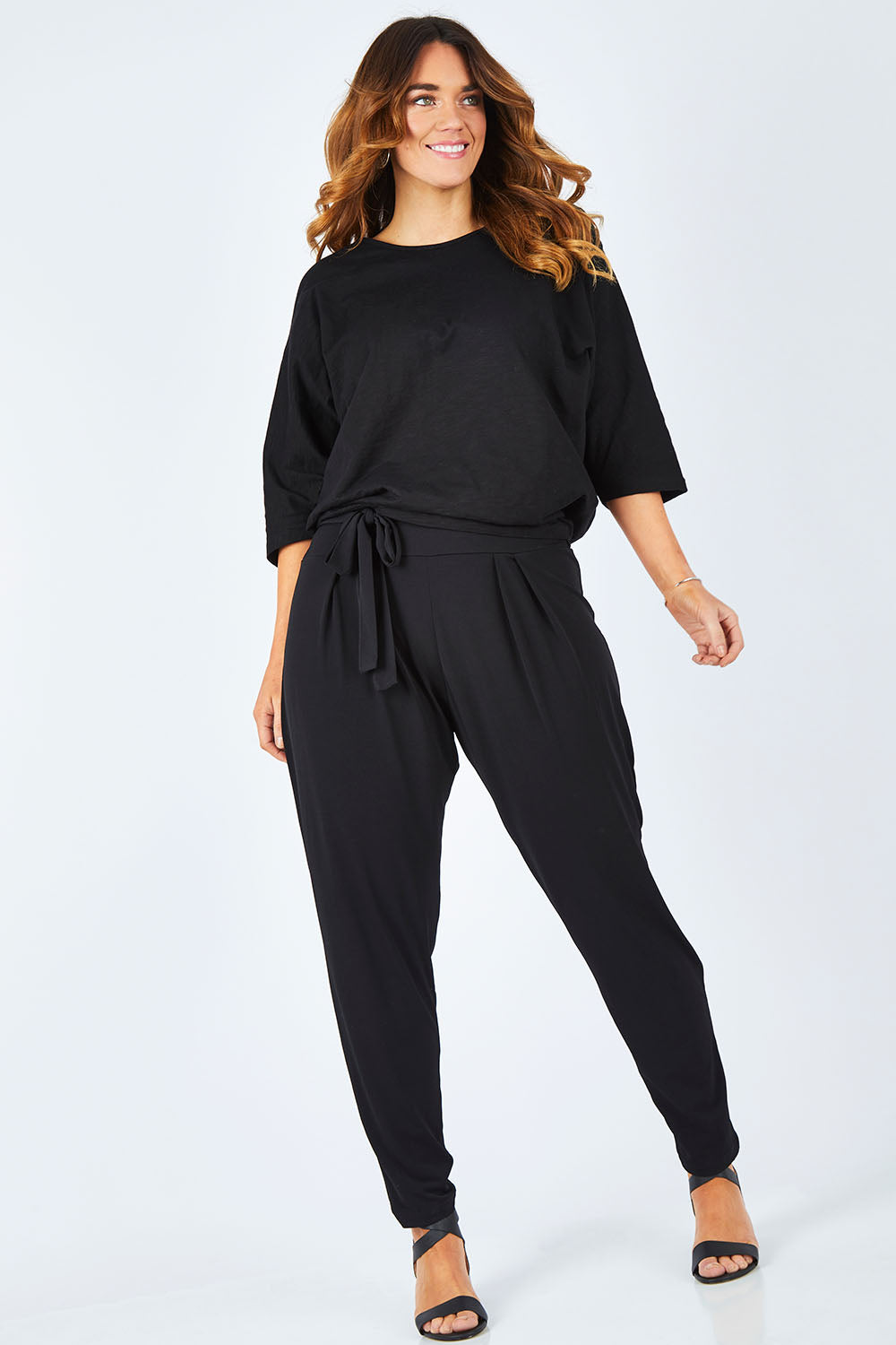 Model Laura wearing size 14 of The Comfort Pant in colour Black (Black), from the front, showing the whole outfit