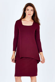 Model Rebecca wearing size 10 of The Long Rita Dress in colour Port (Purple), from the front, cropped image