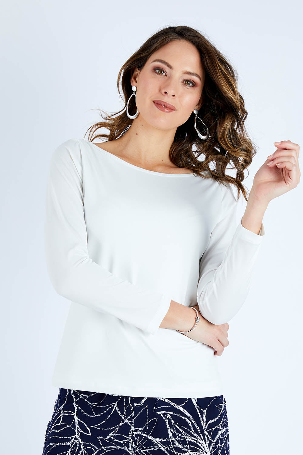 Model Madeline wearing size 10 of The Boat Neck Top in colour Ivory (White), from the front, cropped image