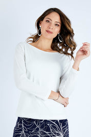 Model Madeline wearing size 10 of The Boat Neck Top in colour Ivory (White), from the front, cropped image
