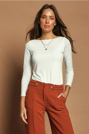 Model Madeline wearing size 10 of The Boat Neck Top in colour Ivory (White), from the front, showing the whole outfit
