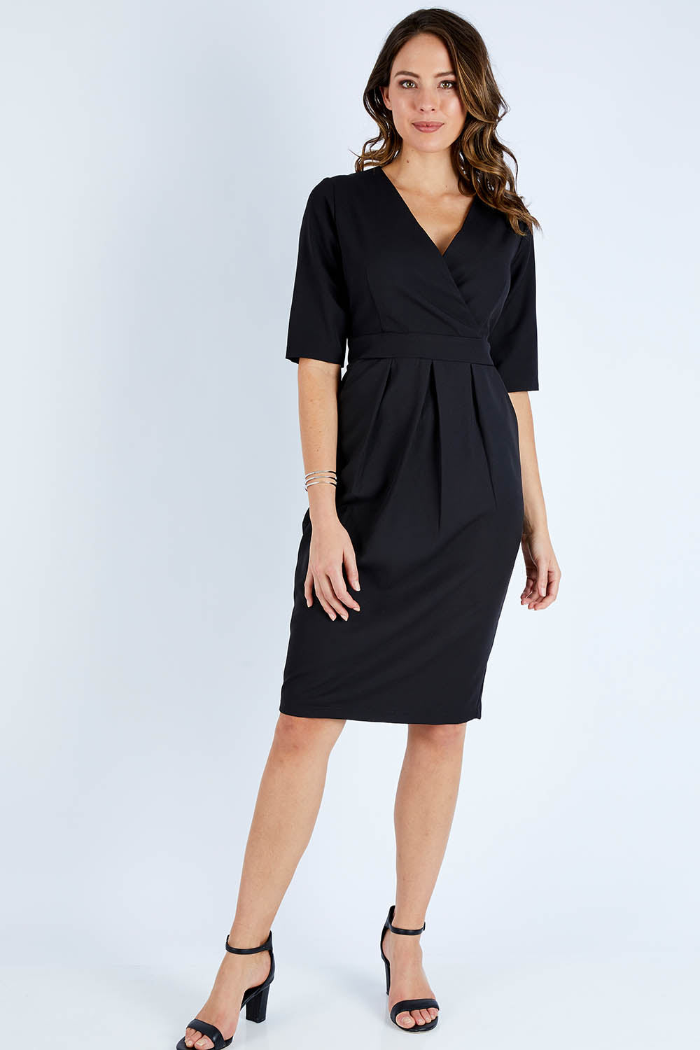 Model Madeline wearing size 10 of The Half Sleeve Tulip Dress in colour Black (Black), from the front, showing the whole outfit